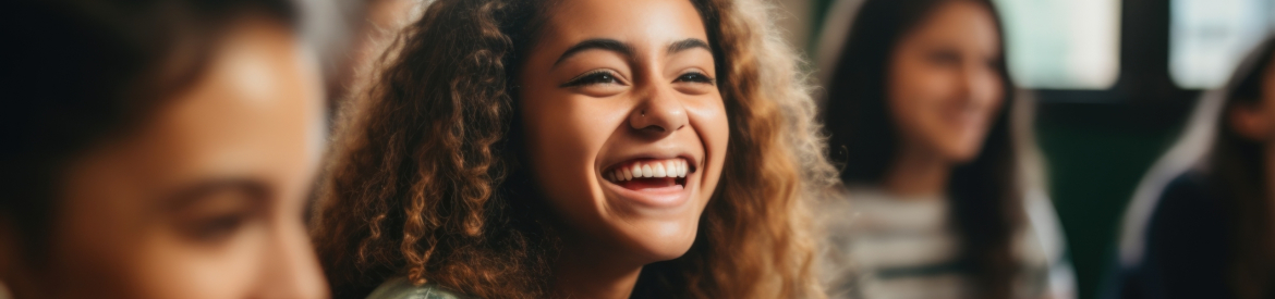 Happy diverse high school students talking in class